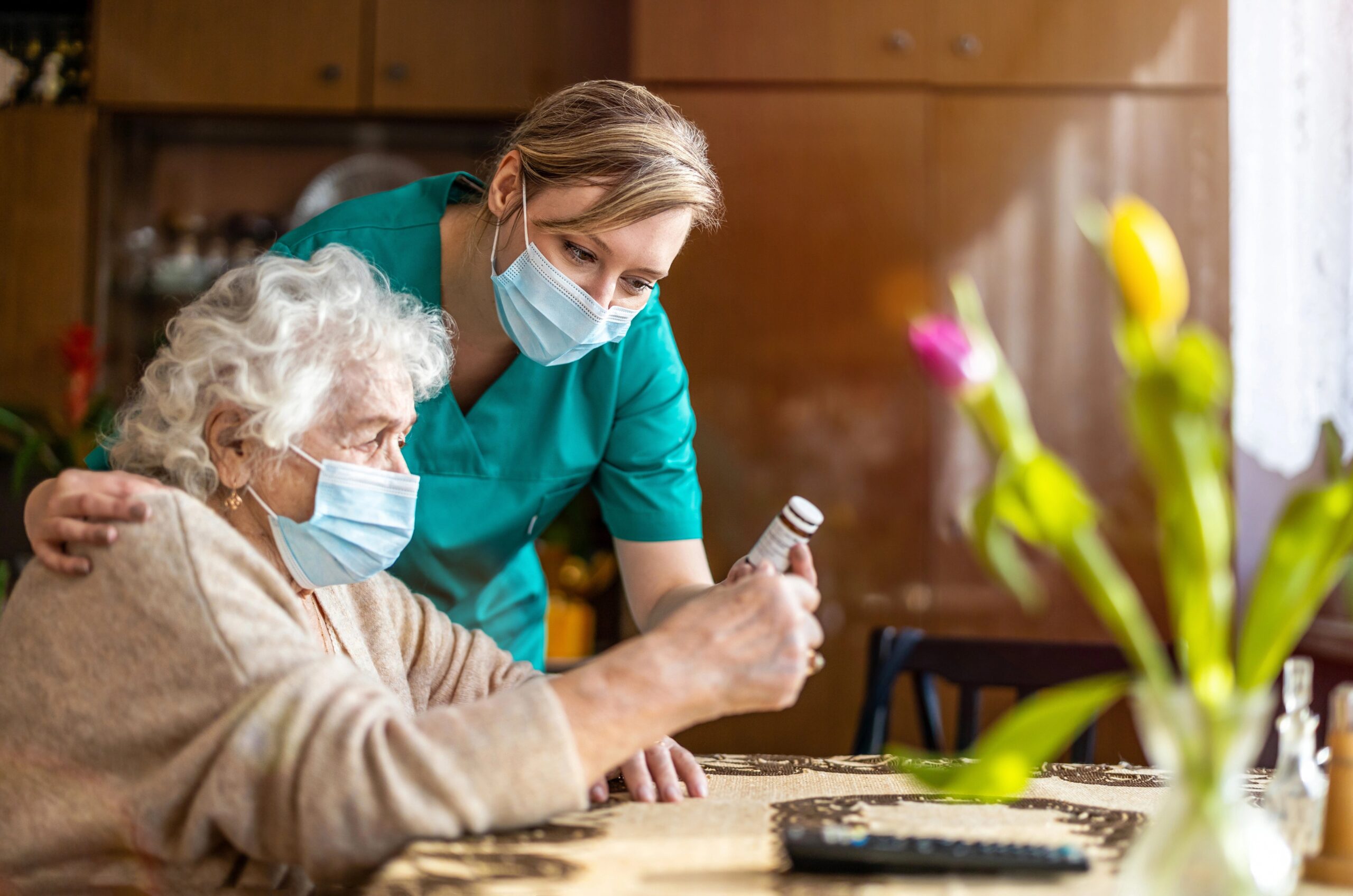 nurse and old woman reading the medicine