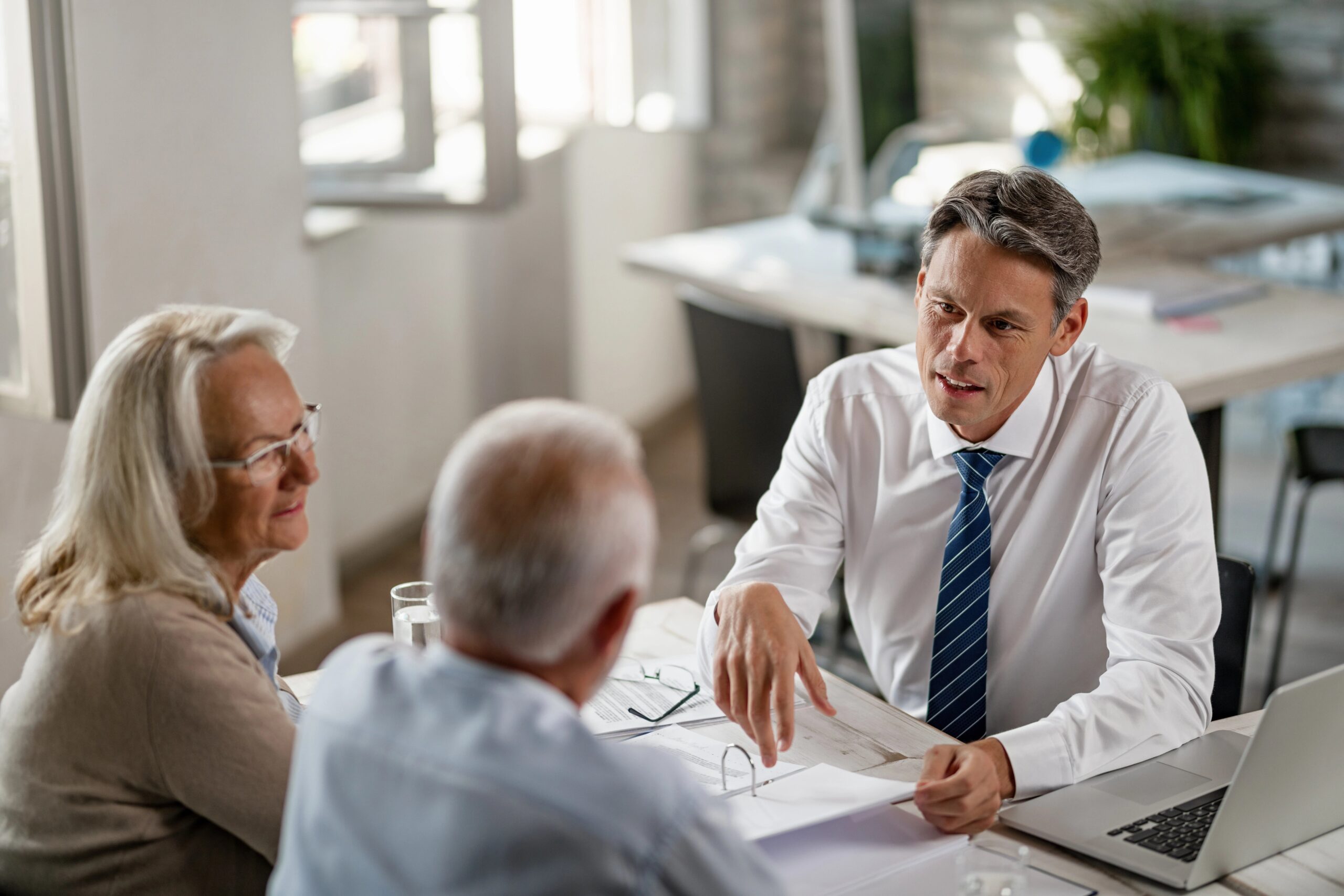 professional going over some documents with an older couple