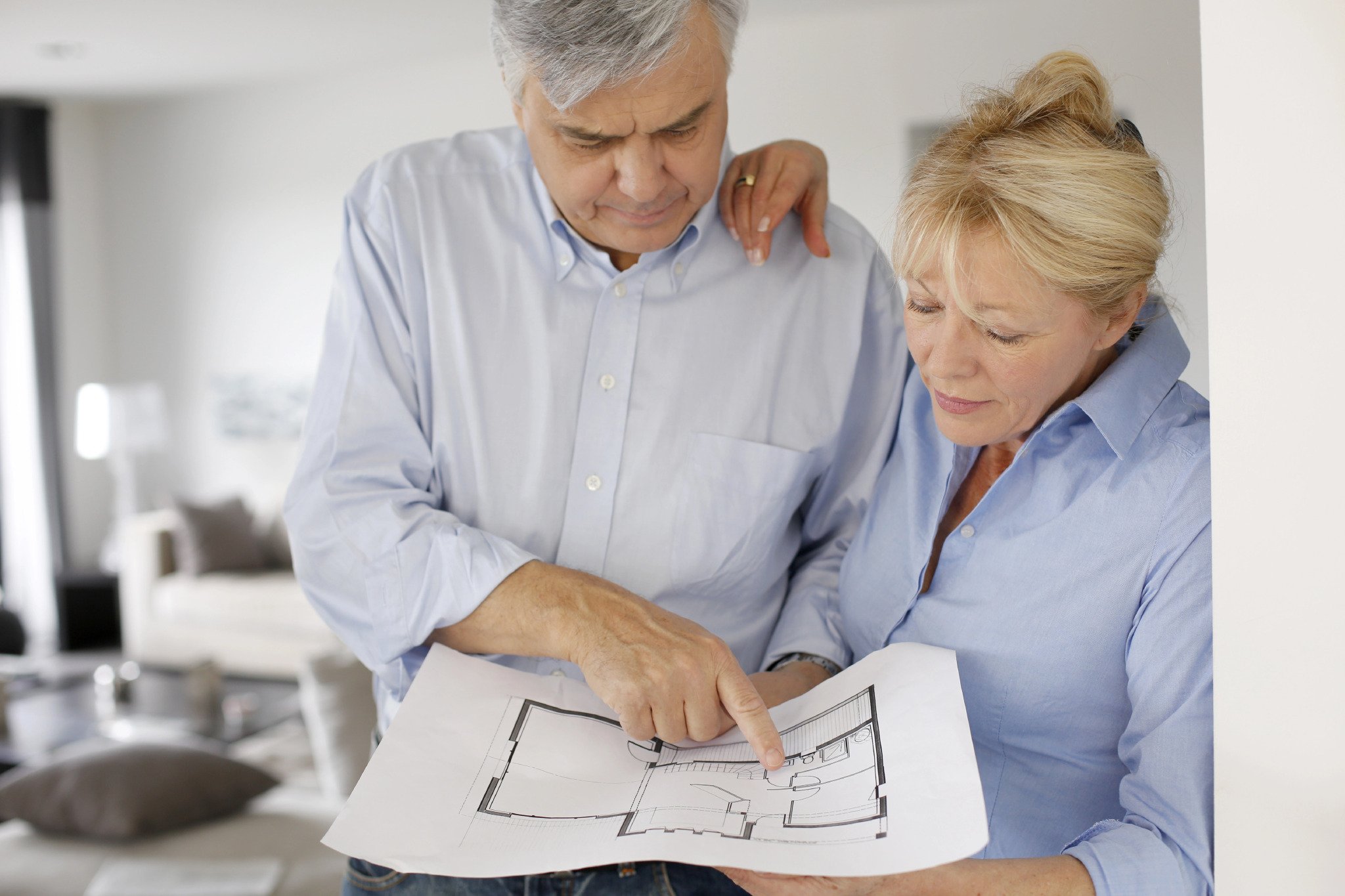 old couple looking at a floor plan