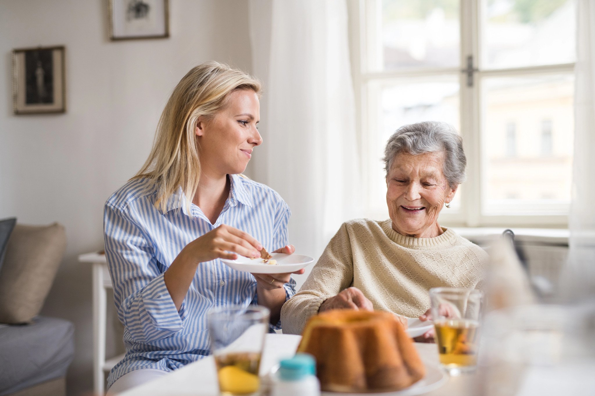 old woman and her daughter eating snack