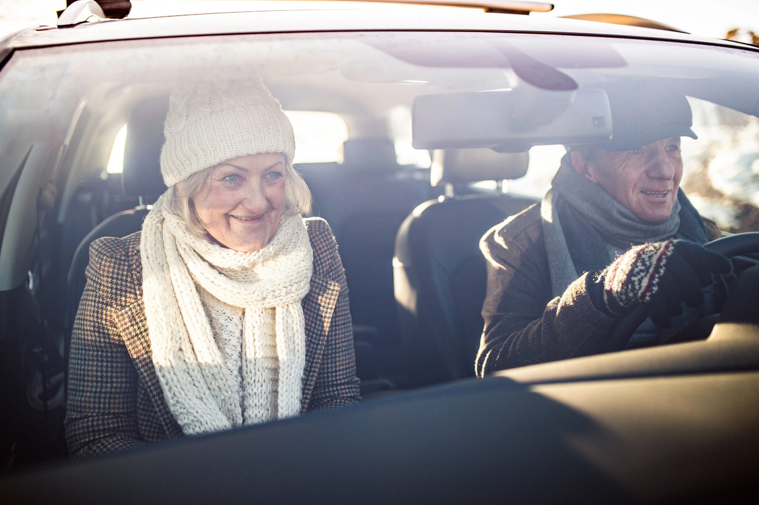 senior couple inside a car