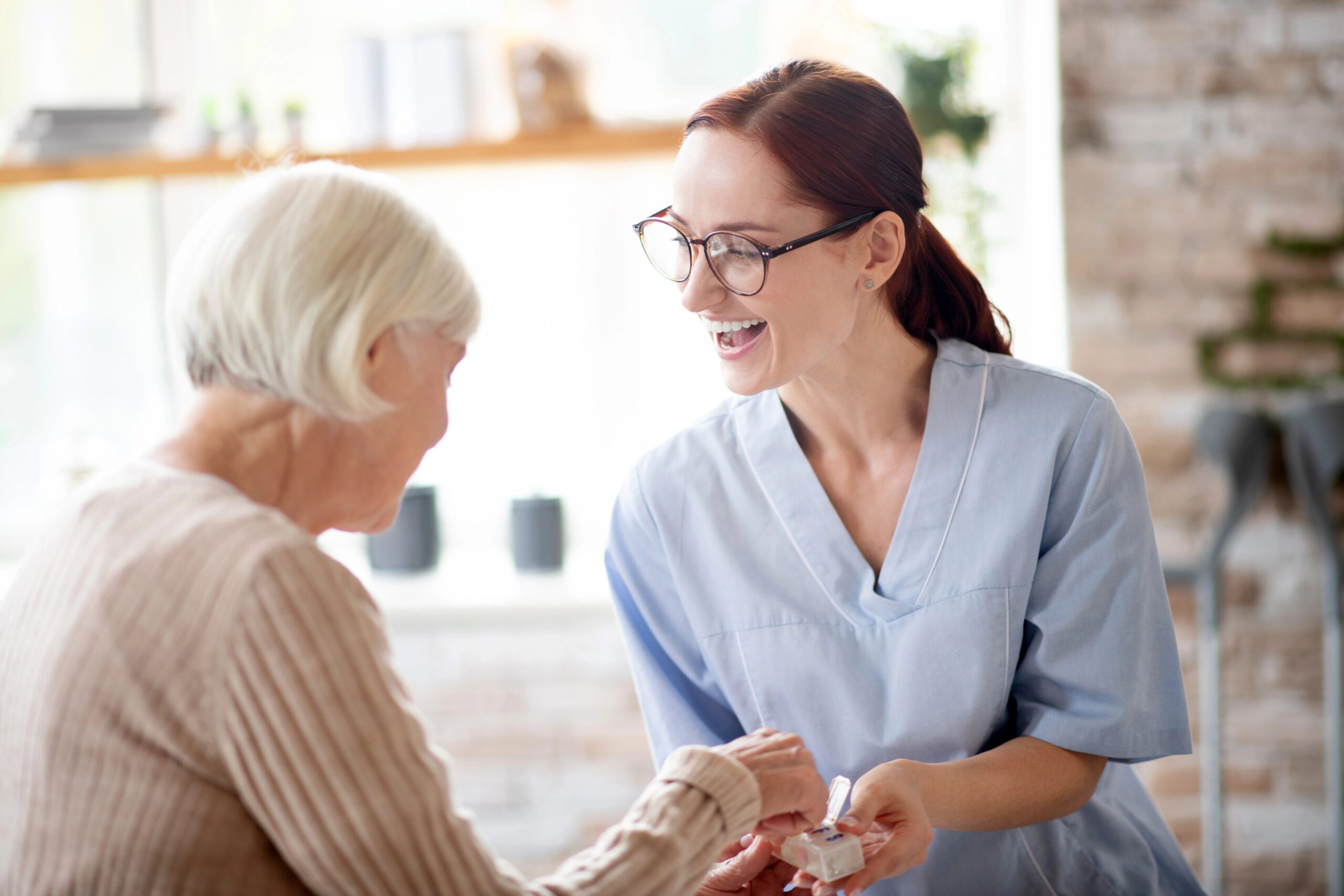 old woman and nurse talking